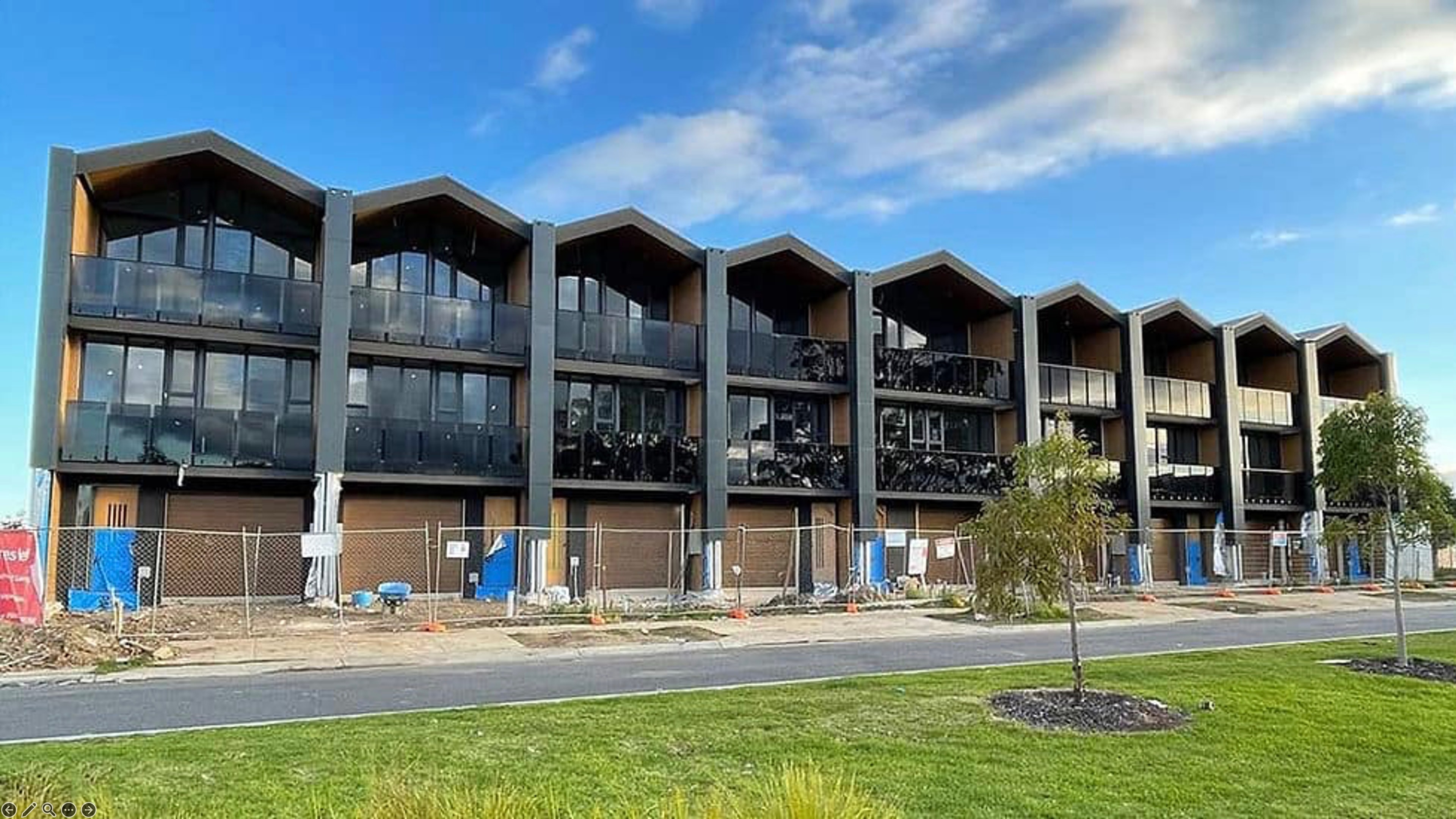 Completed contemporary row homes built with light steel framing