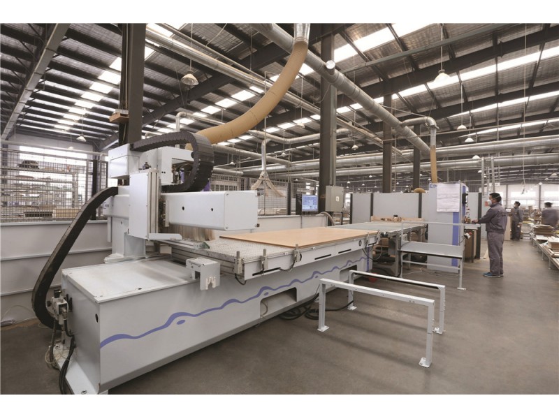 Computer-controlled manufacturing equipment operating inside a production facility